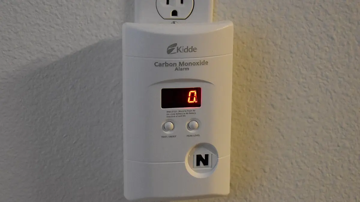 Plug-in carbon monoxide alarm on a wall