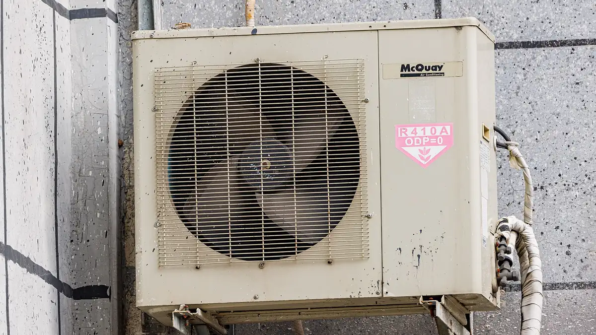 Outdoor air conditioner unit mounted on a wall bracket